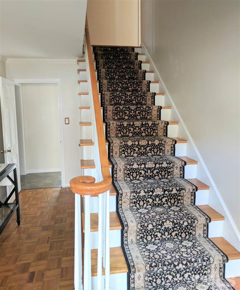 1004 Wofford Lane Raleigh, NC 27609 - Photo 4 of 13 a view of a staircase with wooden floor and a white wall
