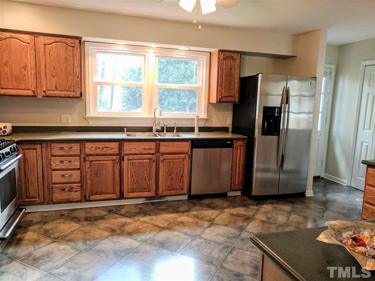 1004 Wofford Lane Raleigh, NC 27609 - Photo 6 of 13 a kitchen with stainless steel appliances granite countertop a refrigerator a stove a sink and dishwasher