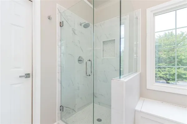 a bathroom with a shower and a window