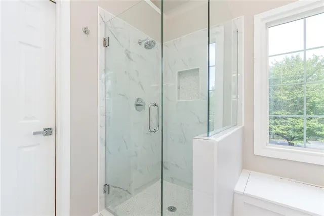 a bathroom with a shower and a window