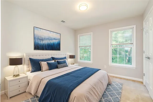 a bedroom with a large bed and a window