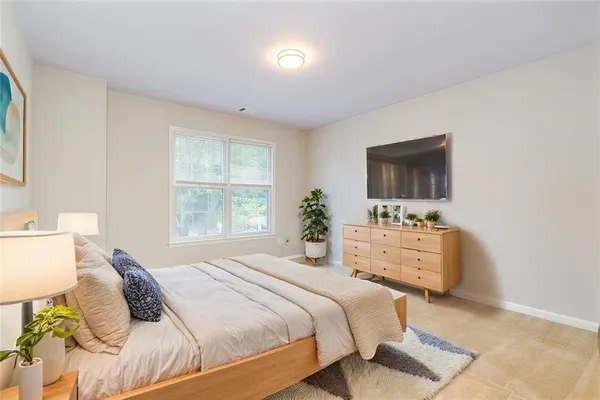 a bedroom with a bed and a flat screen tv