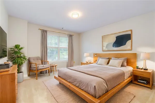 a bedroom with a bed and a window