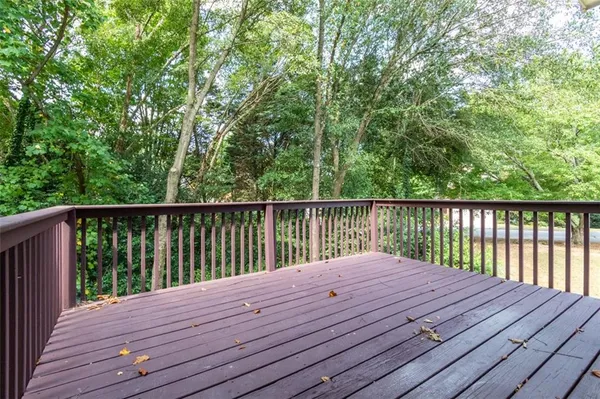 a balcony with wooden floor and fence