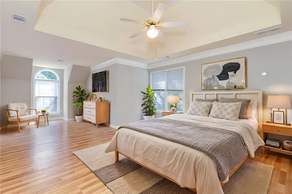 a bedroom with a bed and wooden floor