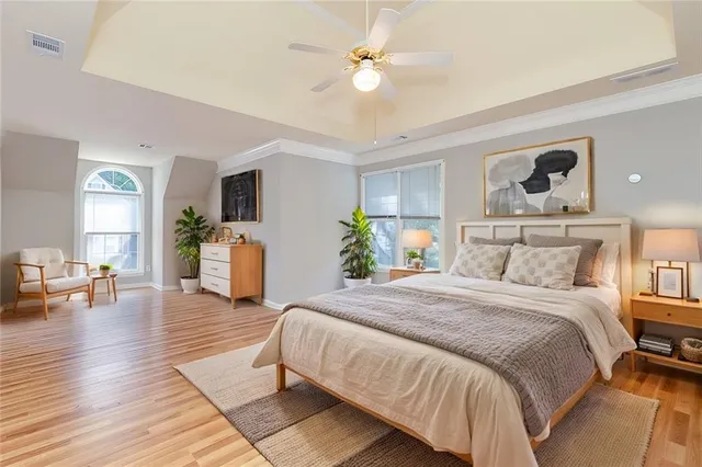 a bedroom with a bed and wooden floor