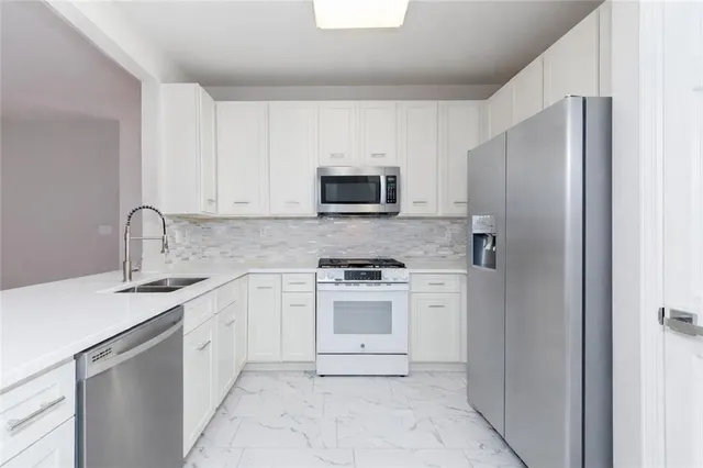 a kitchen with a sink stove and refrigerator