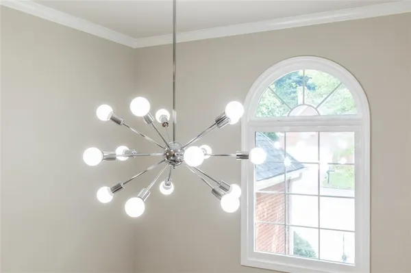 a view of a big room with wooden floor fan and windows