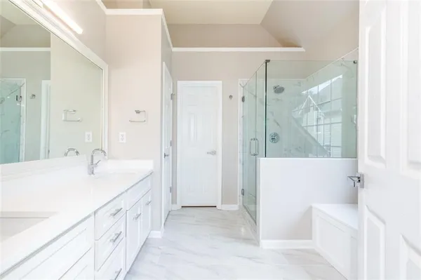 a spacious bathroom with a tub sink and shower