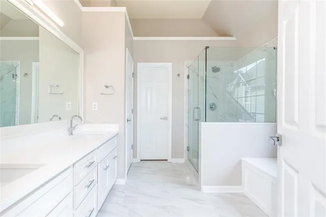 a spacious bathroom with a tub sink and shower