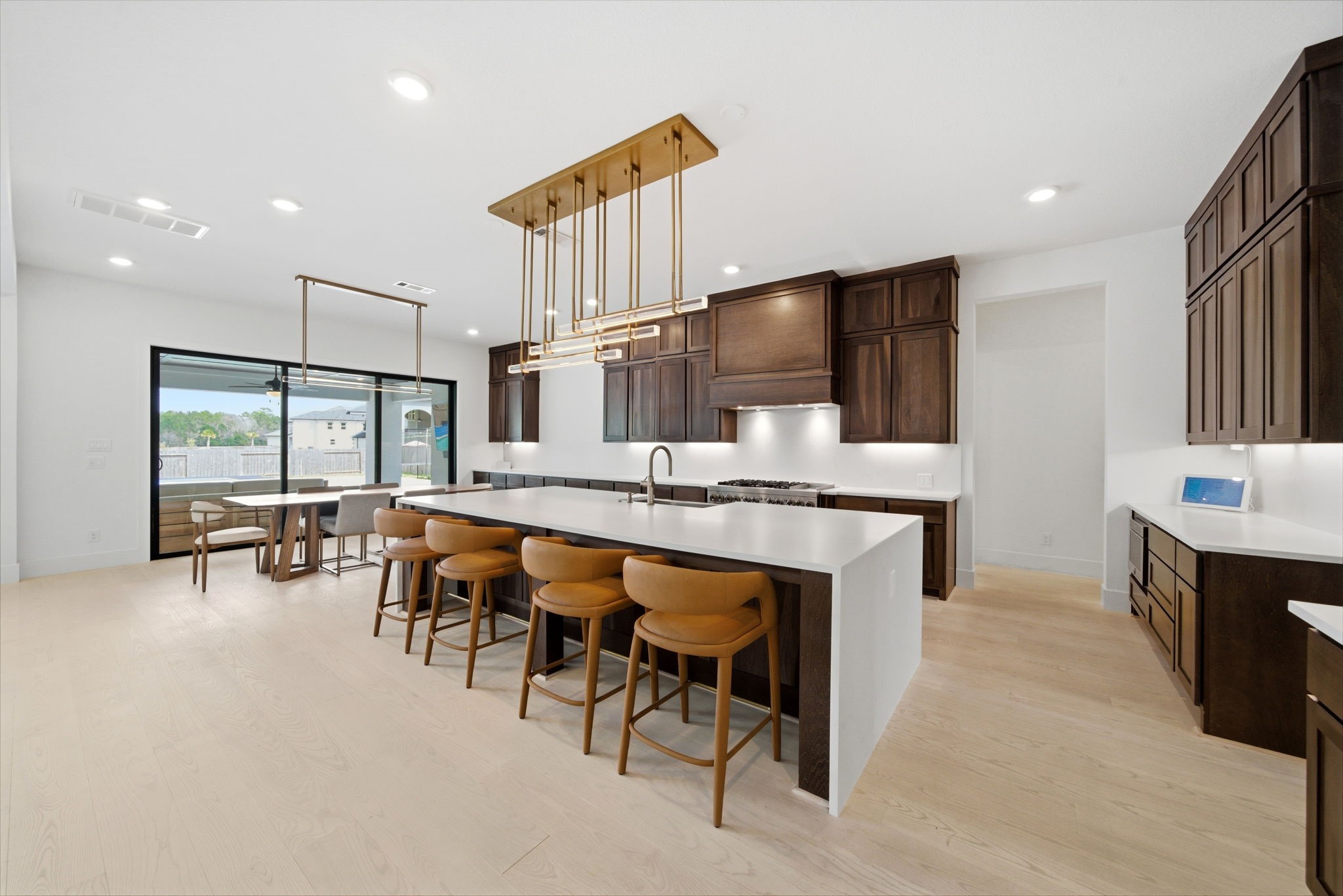 4906 Lagos Lagoon Way Spring, TX 77389 - Photo 15 of 48 Sleek modern kitchen with custom cabinetry and quartz counters.