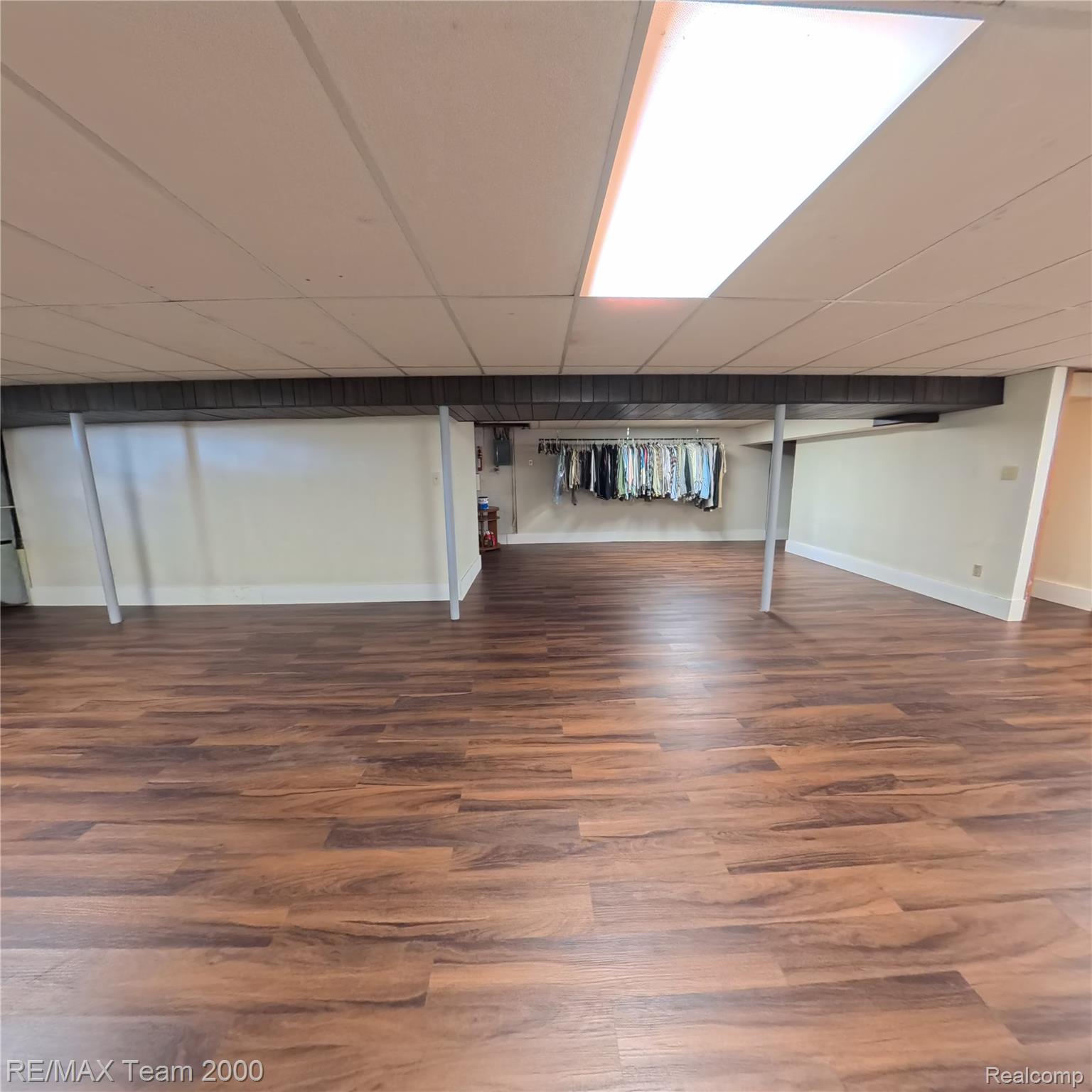 2104 Whittier Road Ypsilanti, MI 48197 - Photo 36 of 45 Finished below grade area featuring dark wood-style flooring and a paneled ceiling