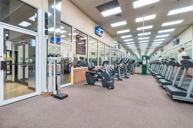 a living room with lots of furniture and kitchen