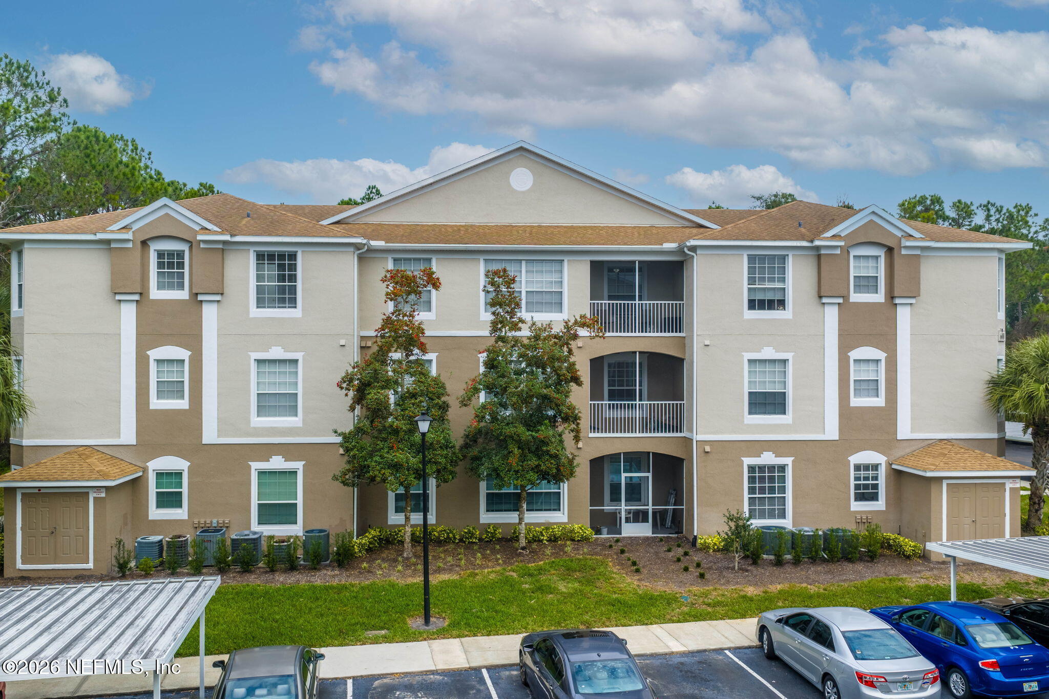 10550 Baymeadows Road, Unit 601 Jacksonville, FL 32256 - Photo 1 of 37 a front view of a house with a yard