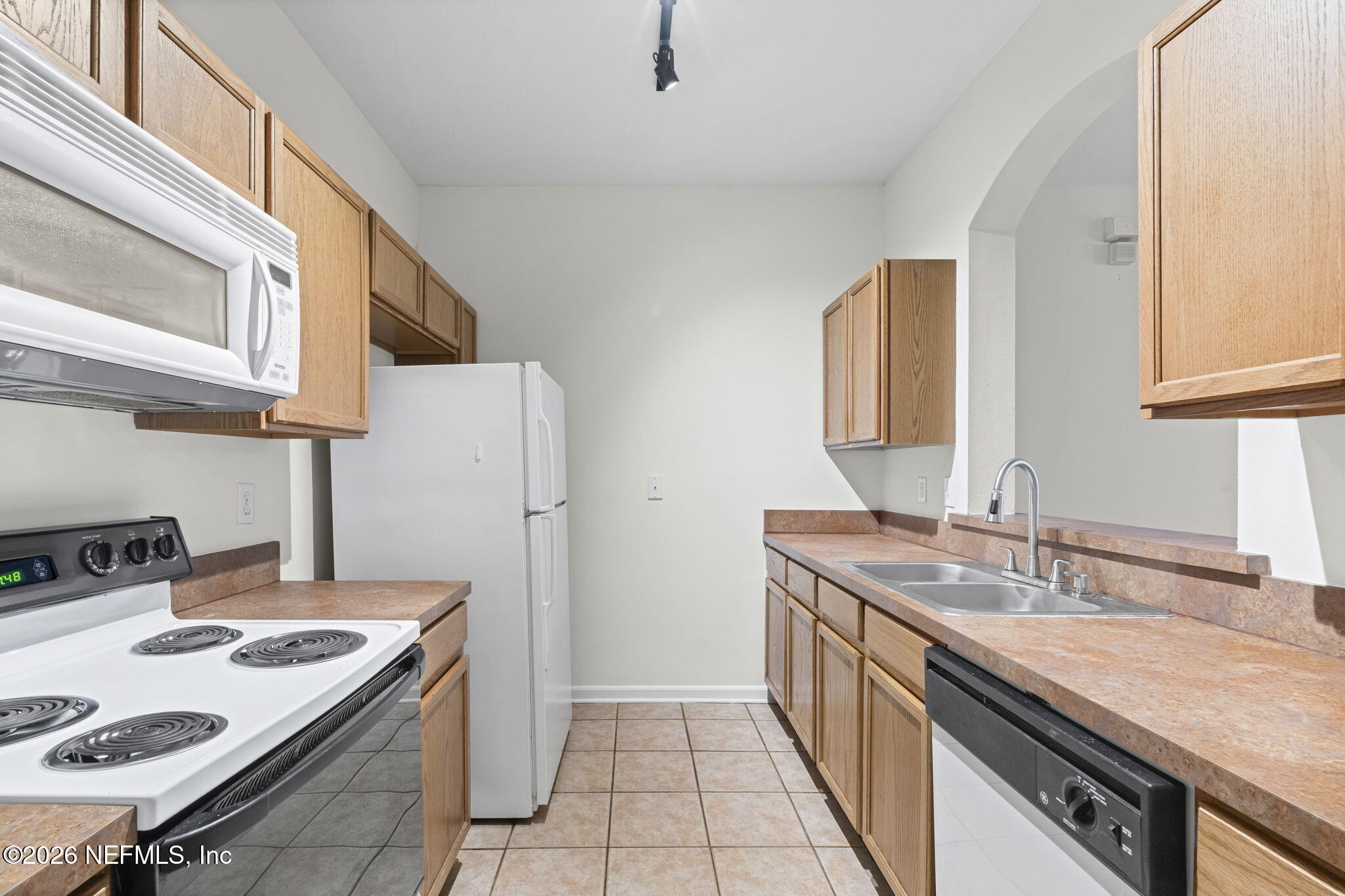 10550 Baymeadows Road, Unit 601 Jacksonville, FL 32256 - Photo 17 of 37 a kitchen with a sink stove and cabinets