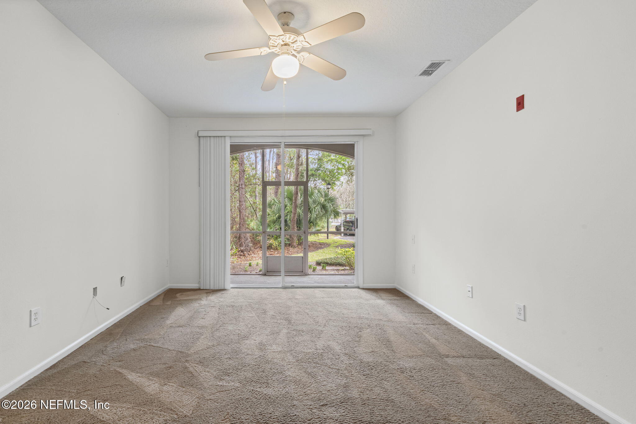 10550 Baymeadows Road, Unit 601 Jacksonville, FL 32256 - Photo 26 of 37 an empty room with chandelier fan and windows