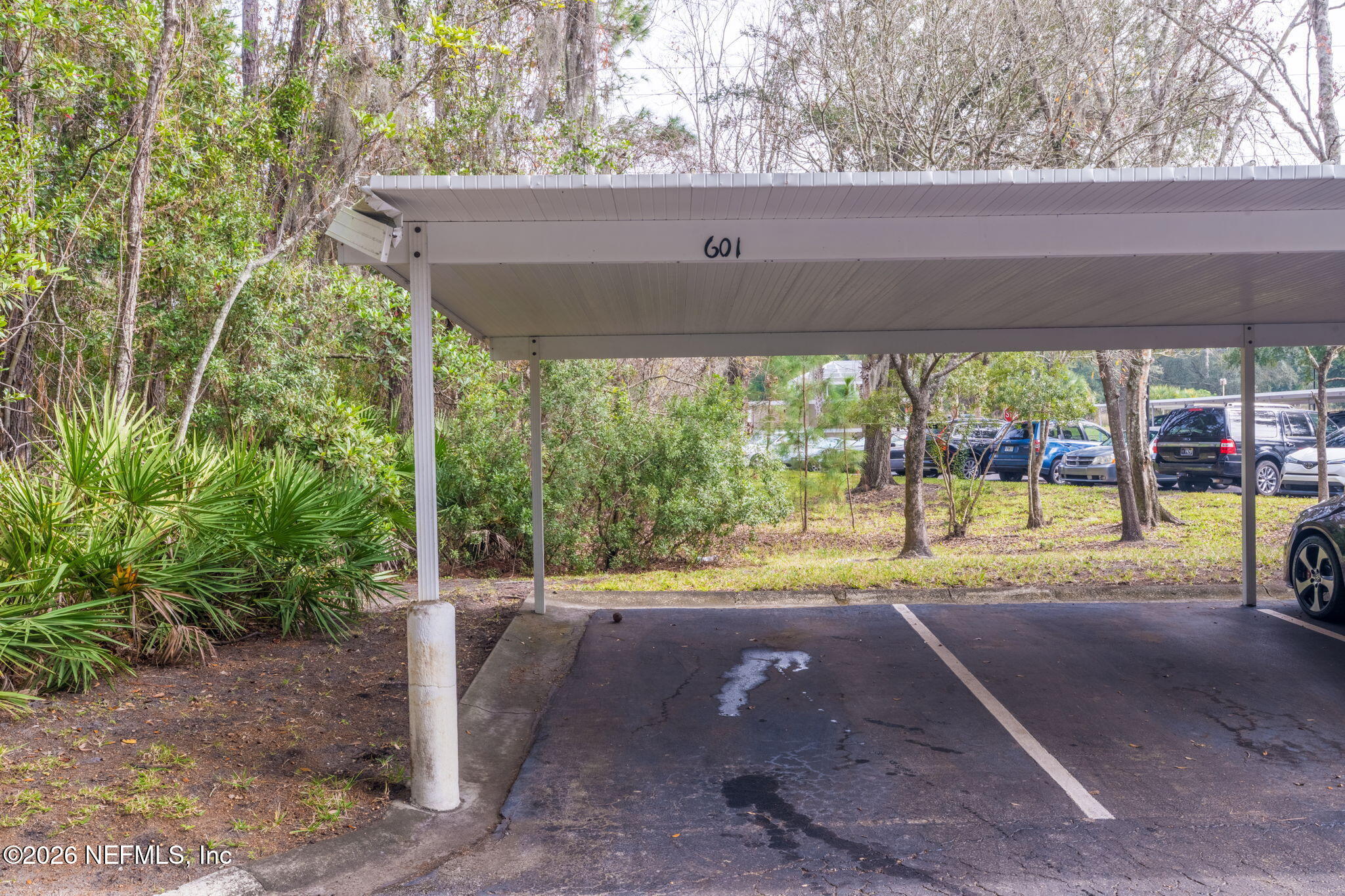 10550 Baymeadows Road, Unit 601 Jacksonville, FL 32256 - Photo 30 of 37 a view of a patio with a table and chairs under an umbrella
