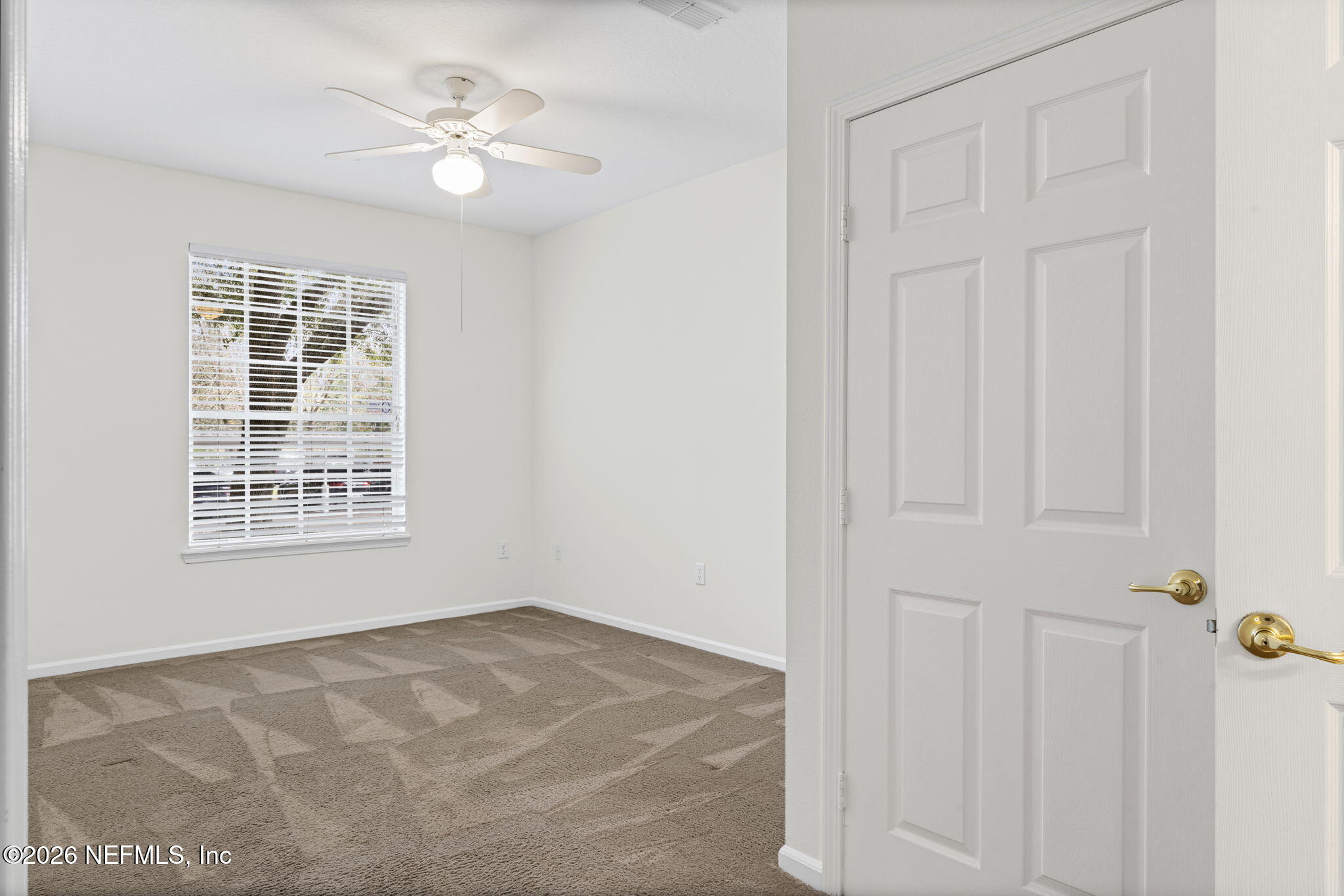 10550 Baymeadows Road, Unit 601 Jacksonville, FL 32256 - Photo 6 of 37 an empty room with windows and ceiling fan