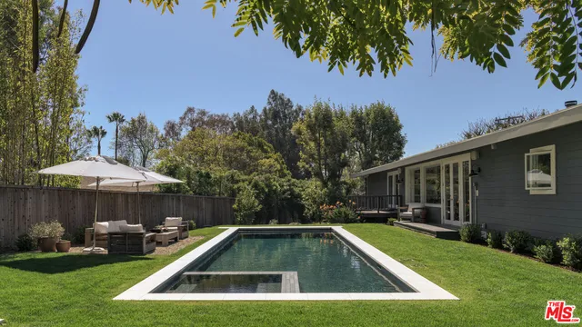 a view of a house with swimming pool and sitting area