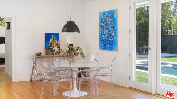 a view of a dining room with furniture window and wooden floor