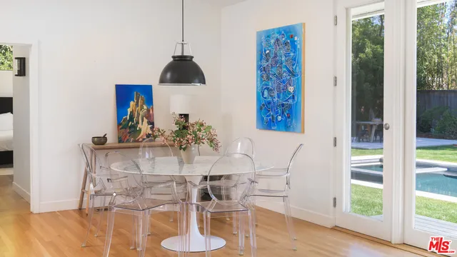 a view of a dining room with furniture window and wooden floor