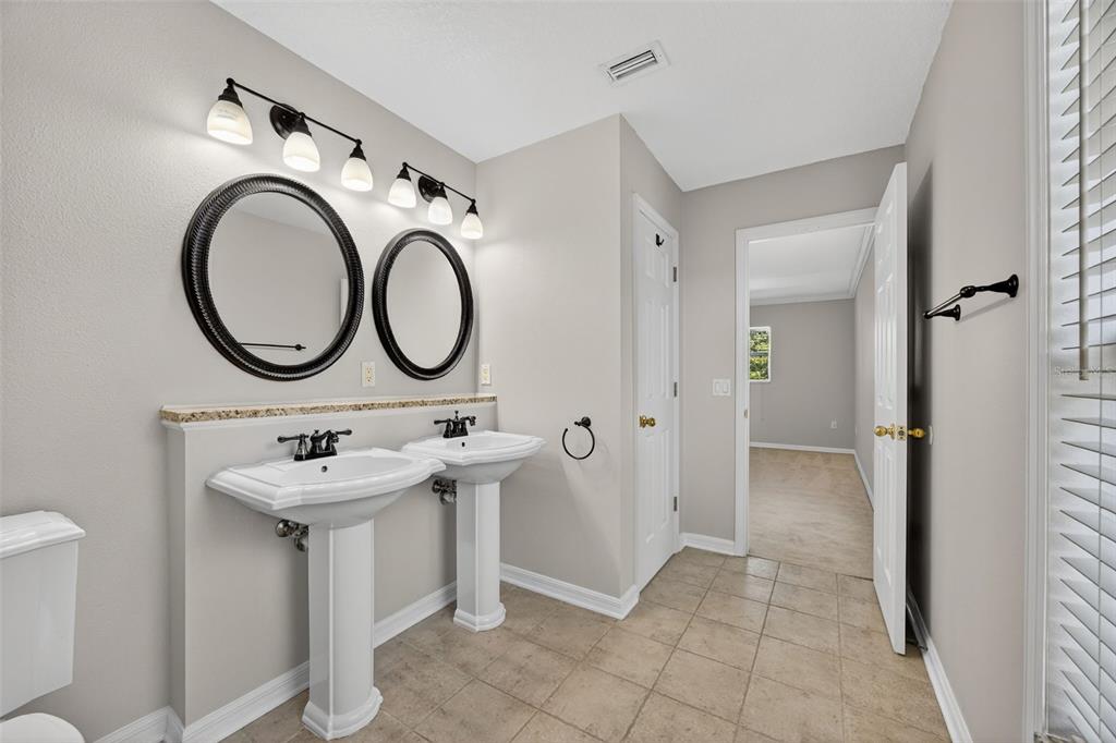 6611 Gates Pointe Way Riverview, FL 33578 - Photo 19 of 55 a bathroom with a sink and a mirror
