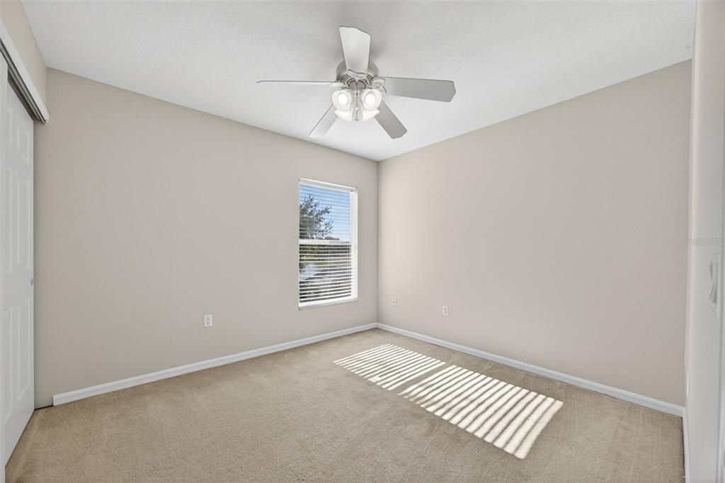 6611 Gates Pointe Way Riverview, FL 33578 - Photo 21 of 55 an empty room with windows and fan
