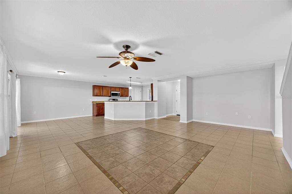 6611 Gates Pointe Way Riverview, FL 33578 - Photo 7 of 55 a view of a livingroom with a ceiling fan a kitchen space and a sink