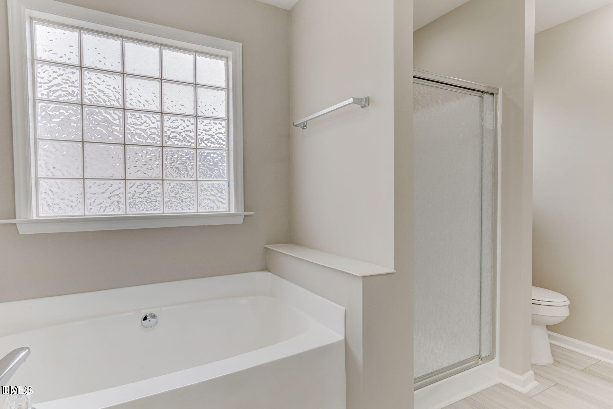 480 Seastone Street Raleigh, NC 27603 - Photo 20 of 26 a bathroom with a bathtub and toilet