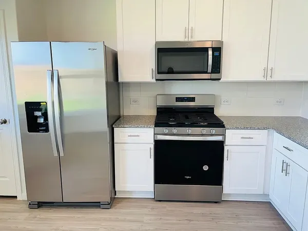 a stove top oven sitting inside of a kitchen