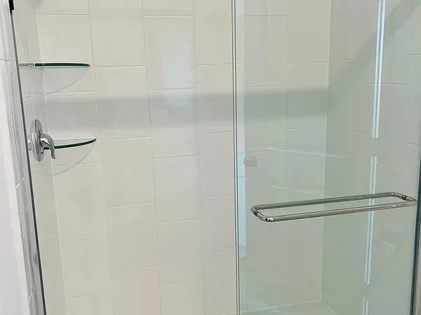 a bathroom with a glass shower door