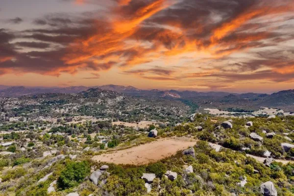 an aerial view of residential houses with city view