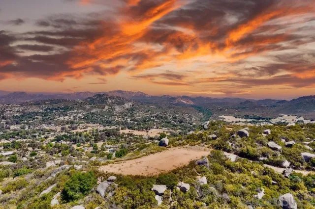 an aerial view of residential houses with city view