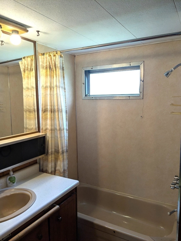 83 Clark Road, Unit 38 Shirley, MA 01464 - Photo 21 of 24 a bathroom with a sink a vanity and a mirror