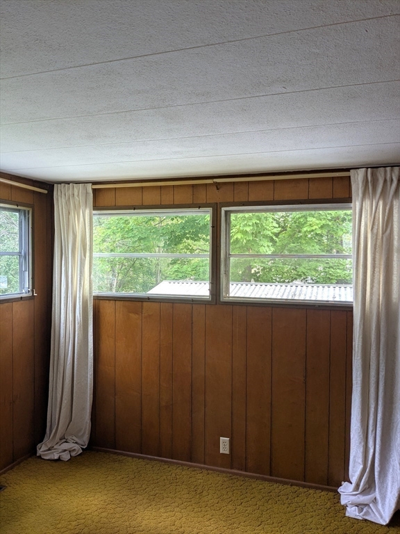 83 Clark Road, Unit 38 Shirley, MA 01464 - Photo 23 of 24 an empty room with wooden floor and windows