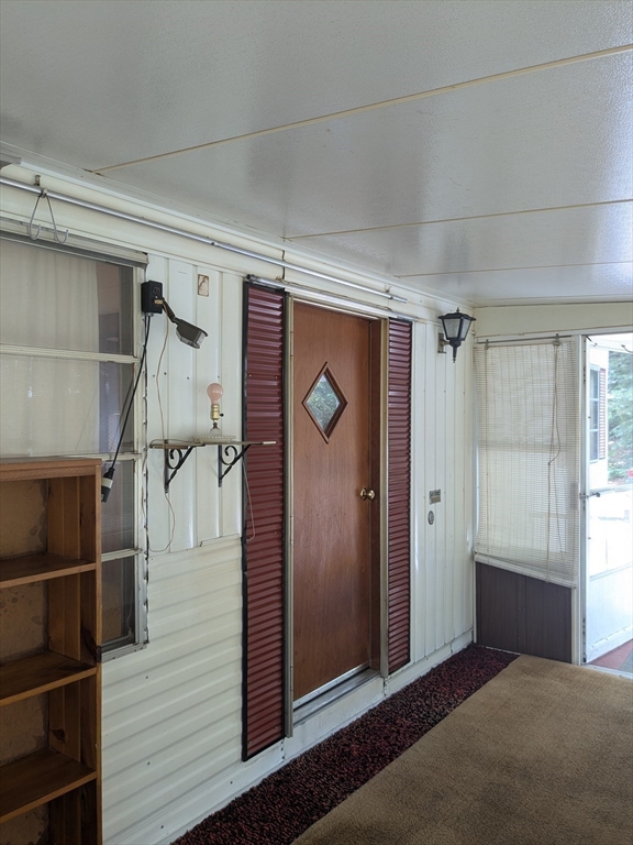 83 Clark Road, Unit 38 Shirley, MA 01464 - Photo 5 of 24 a view of entryway with wooden floor and cabinet