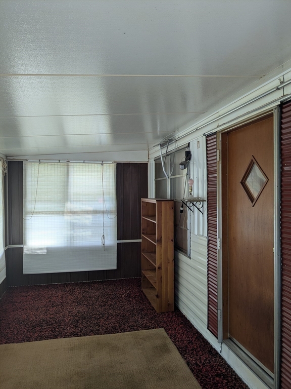 83 Clark Road, Unit 38 Shirley, MA 01464 - Photo 6 of 24 a view of a refrigerator in kitchen and an empty room