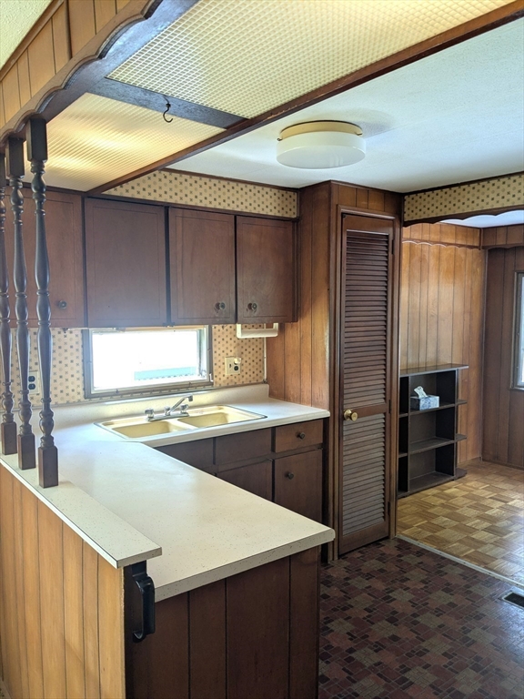 83 Clark Road, Unit 38 Shirley, MA 01464 - Photo 9 of 24 a kitchen with a sink a refrigerator and cabinets
