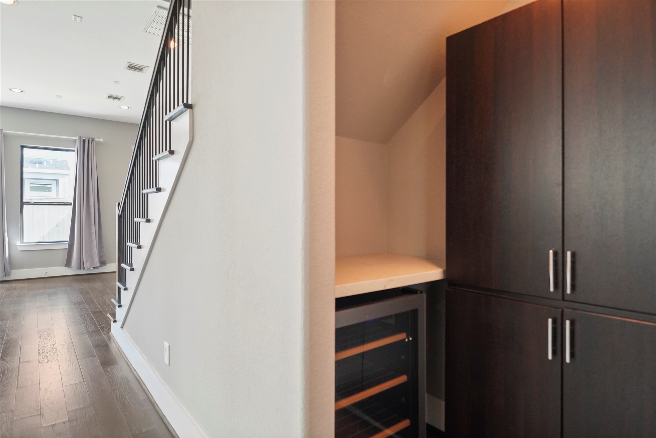 4123 Eigel Street Houston, TX 77007 - Photo 11 of 25 a view of hallway with stairs and wooden floor