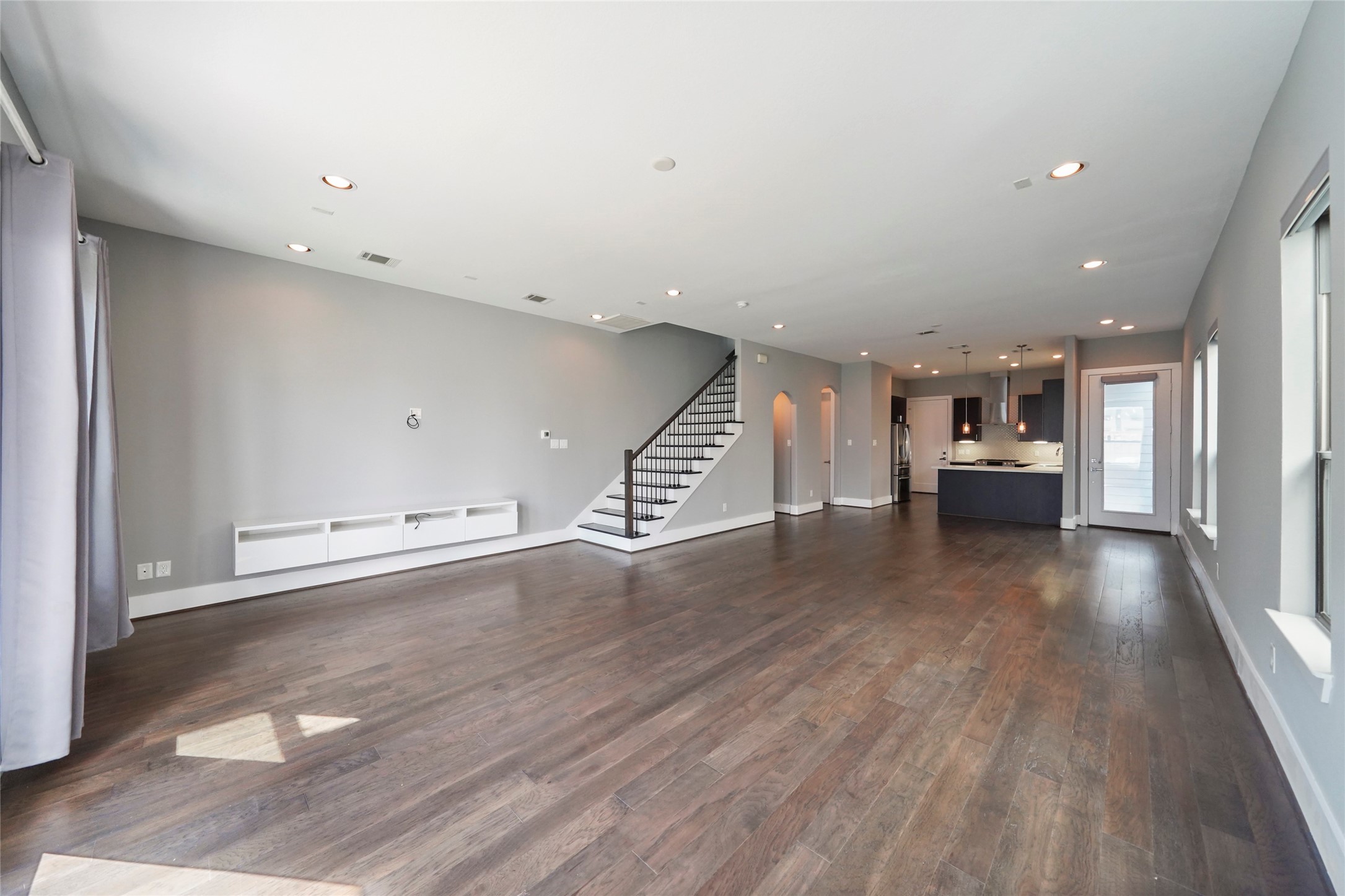 4123 Eigel Street Houston, TX 77007 - Photo 6 of 25 a view of an empty room with wooden floor and stairs