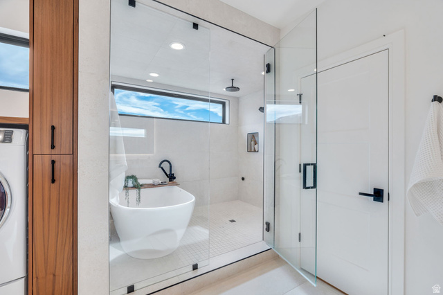 3918 South Mapleton Ests Drive Mapleton, UT 84664 - Photo 37 of 103 Bathroom with washer / dryer, a stall shower, a freestanding tub, recessed lighting, and light tile patterned floors