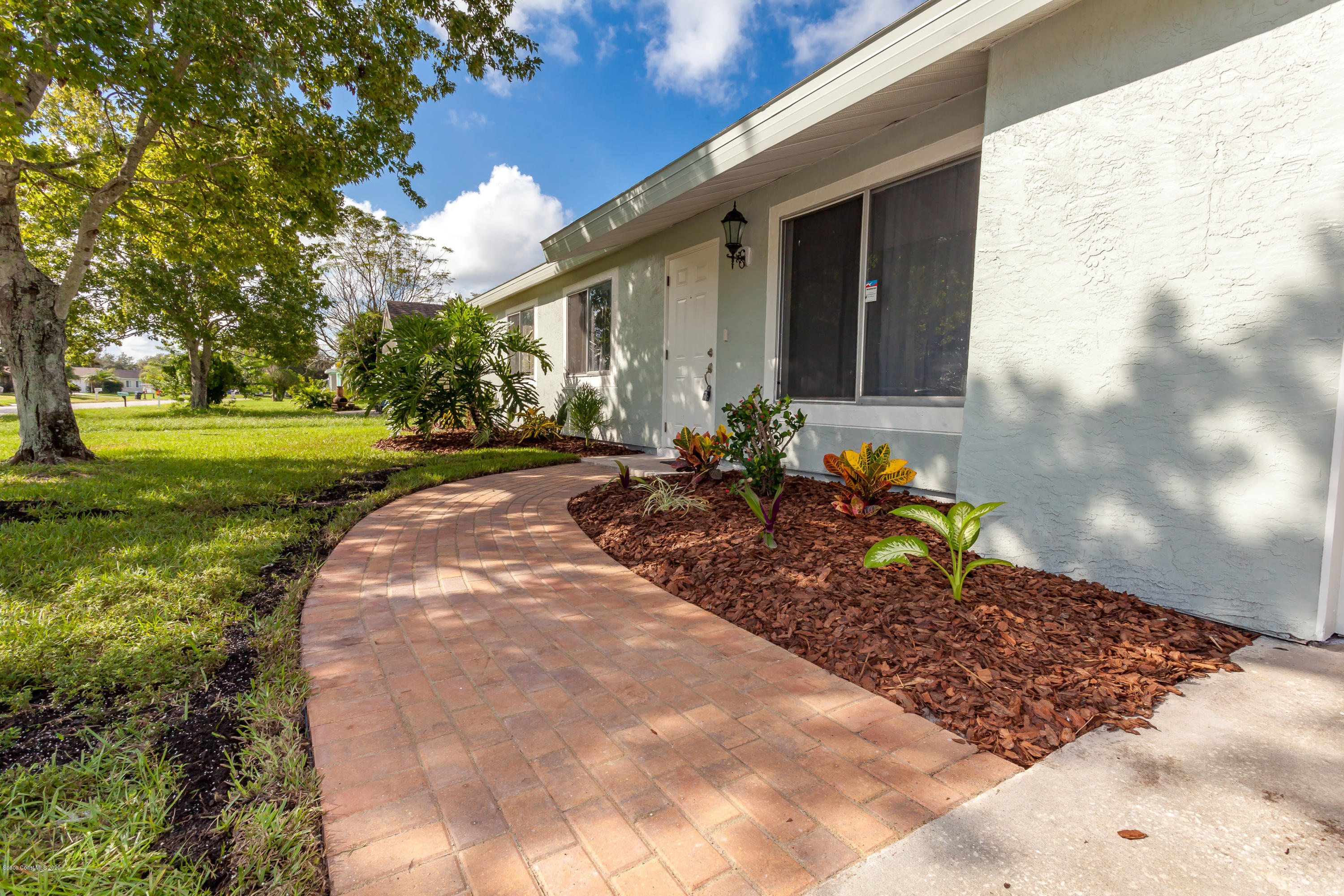 1280 Freil Road Northeast Palm Bay, FL 32905 - Photo 3 of 15 a front view of a house with a yard