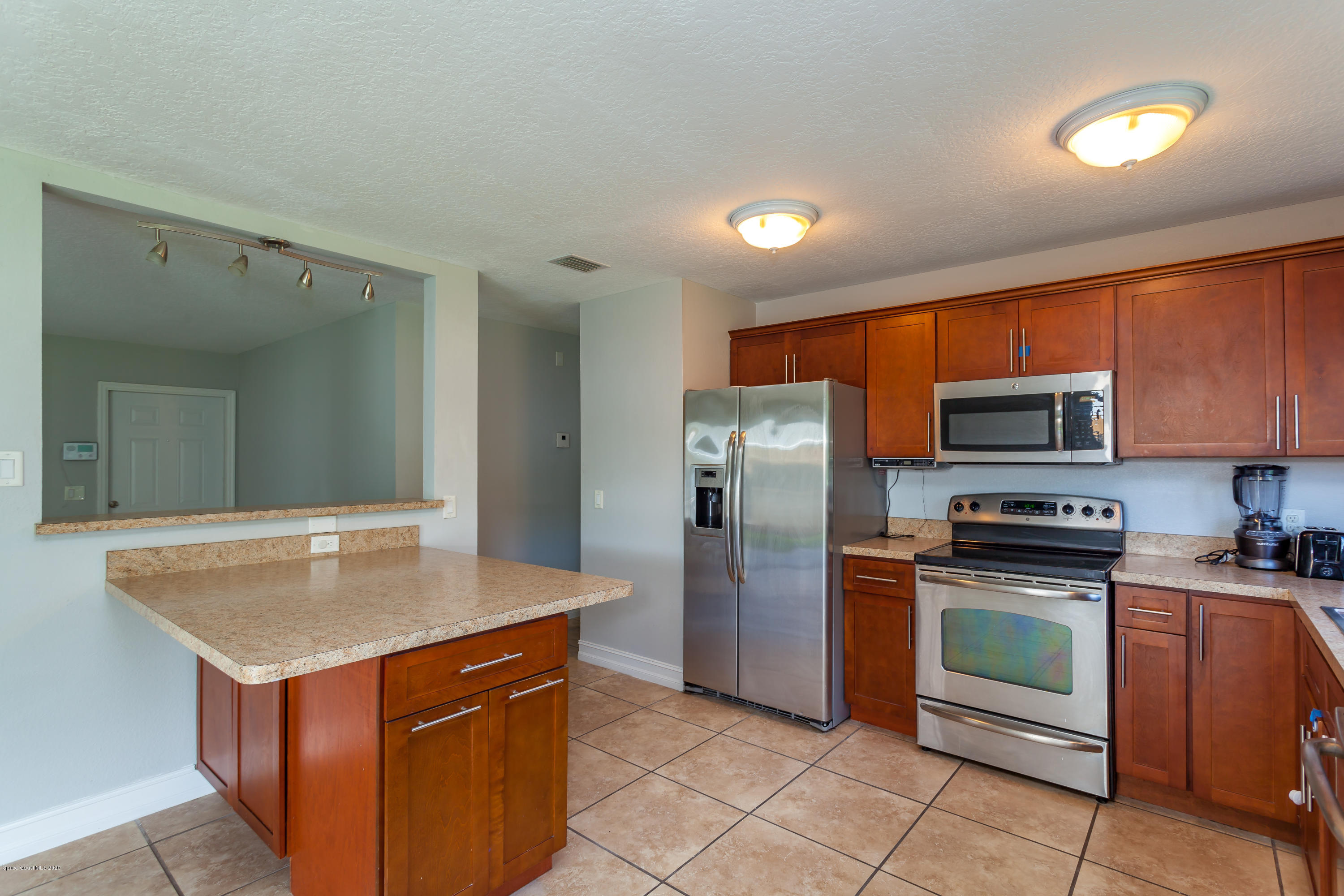 1280 Freil Road Northeast Palm Bay, FL 32905 - Photo 4 of 15 a kitchen with stainless steel appliances granite countertop a stove a refrigerator and a sink