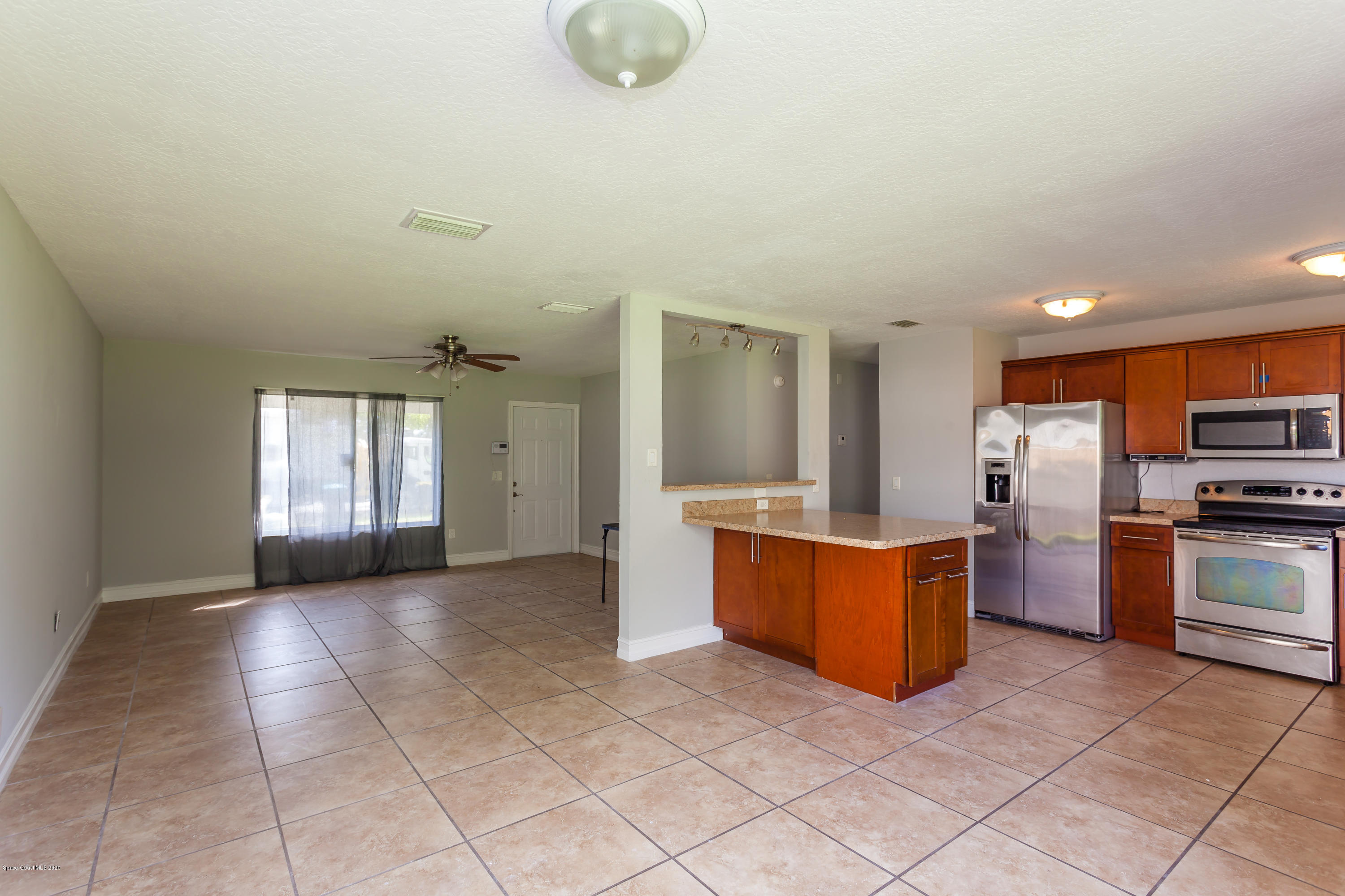 1280 Freil Road Northeast Palm Bay, FL 32905 - Photo 5 of 15 a large kitchen with cabinets and stainless steel appliances