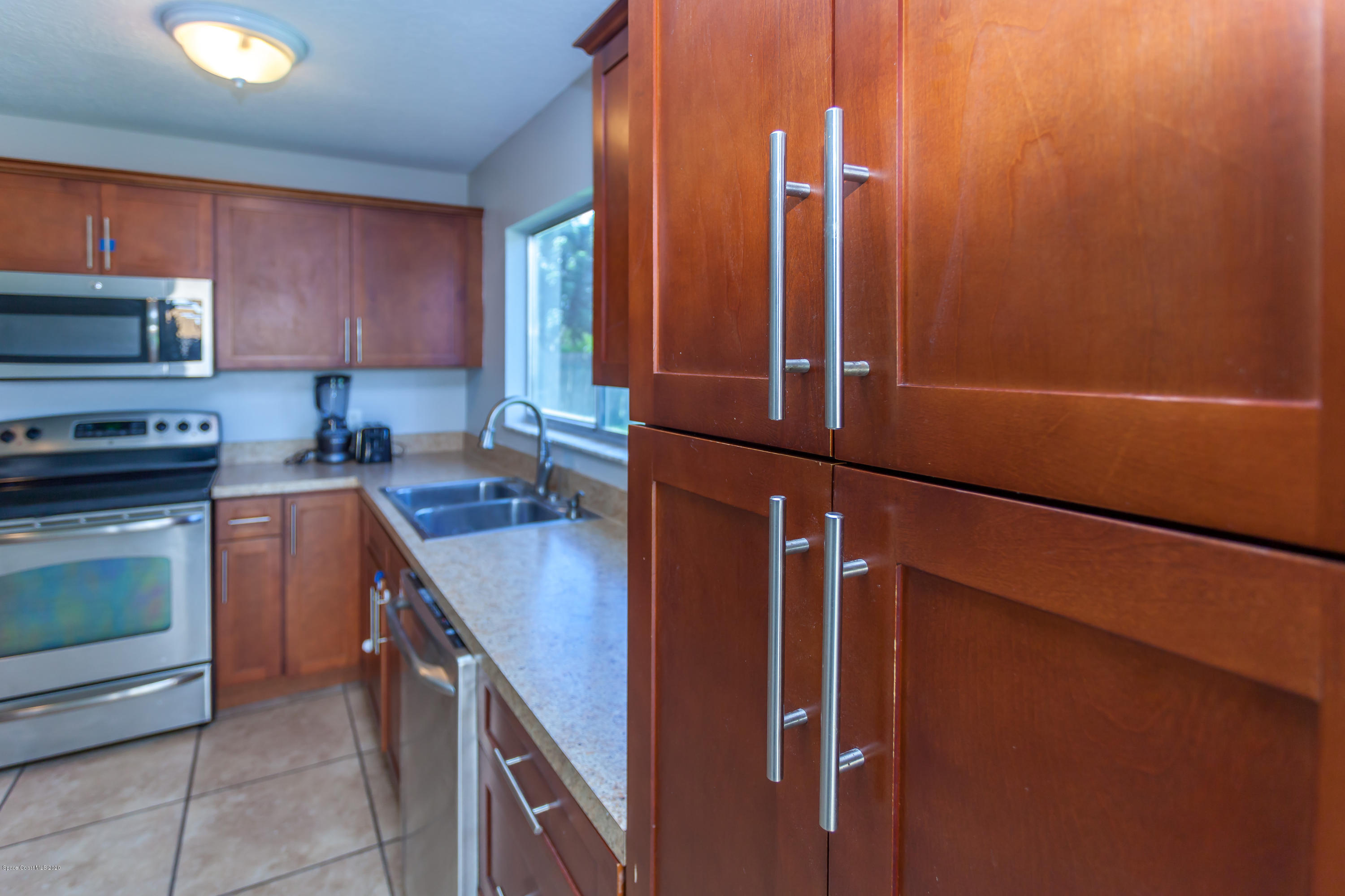 1280 Freil Road Northeast Palm Bay, FL 32905 - Photo 6 of 15 a kitchen with appliances a sink and cabinets