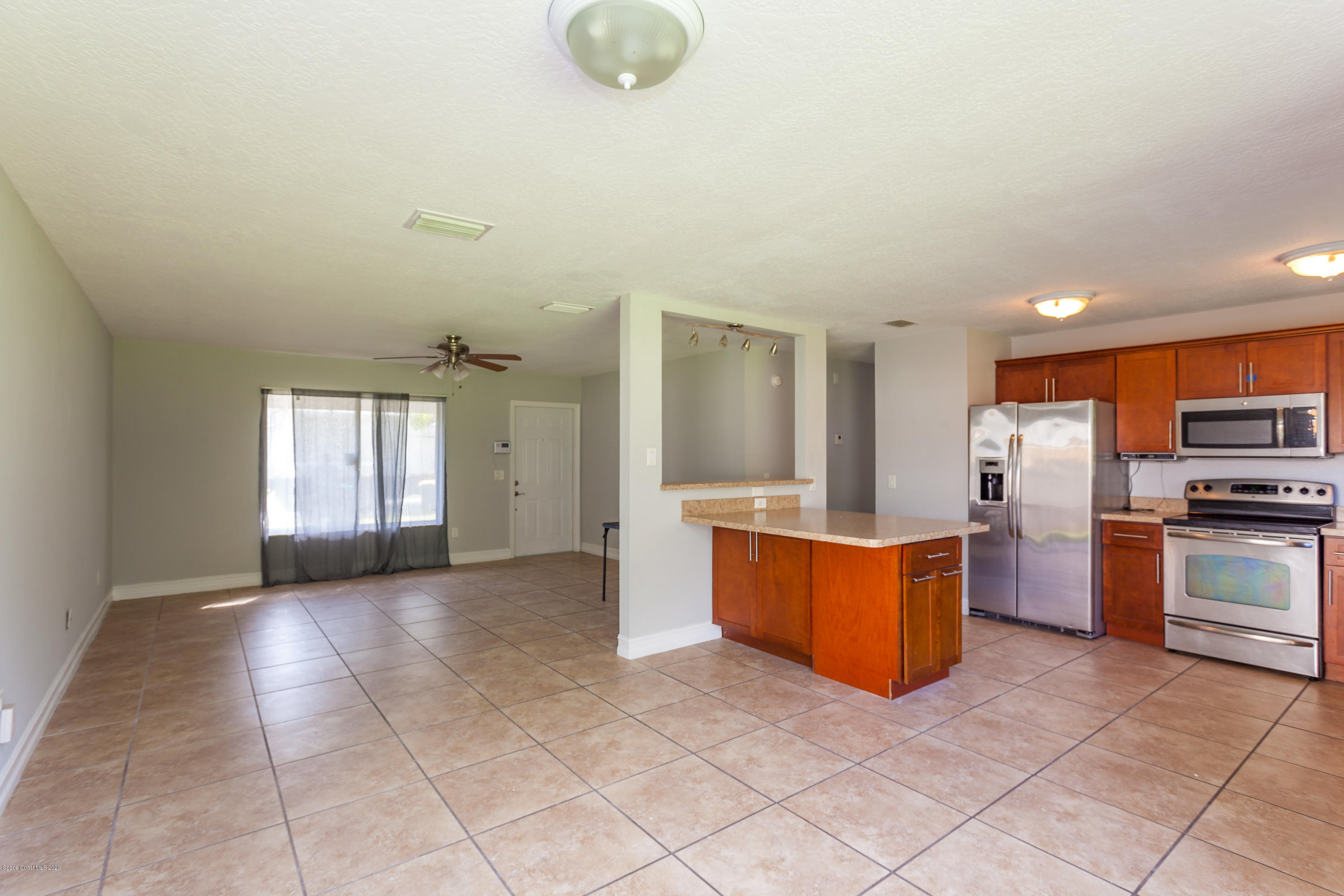 1280 Freil Road Northeast Palm Bay, FL 32905 - Photo 7 of 15 a large kitchen with cabinets and stainless steel appliances