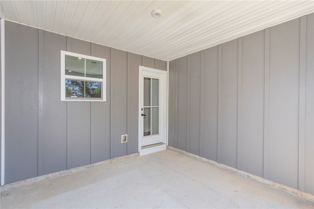 233 Scenic Road Anderson, SC 29621 - Photo 49 of 50 A well-lit covered patio offers a private outdoor space, perfect for relaxation or entertaining.