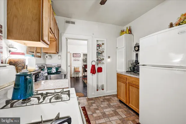 a kitchen with stainless steel appliances granite countertop a refrigerator and a stove