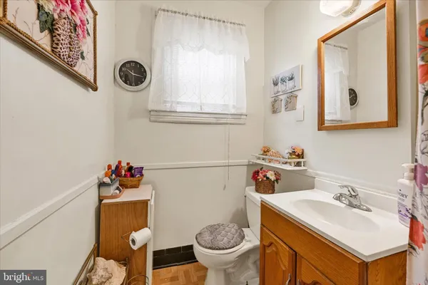 a bathroom with a sink mirror and toilet
