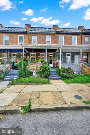 a front view of a residential apartment building with a yard